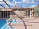 Covered pool area features a sun-shaped decoration on the tiled wall and a relaxing in-ground spa at 9460 Bearfoot Trl, Weeki Wachee, FL 34613