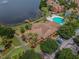 An aerial view shows the community clubhouse, swimming pool and surrounding residential buildings at 9740 Lake Chase Island Way # 9740, Tampa, FL 33626