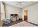 Bedroom view showing wood flooring, fan and access to bathroom at 9740 Lake Chase Island Way # 9740, Tampa, FL 33626