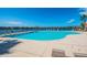 Community pool with lounge chairs and lake view providing a relaxing and picturesque environment at 9740 Lake Chase Island Way # 9740, Tampa, FL 33626