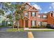 Charming townhouse featuring a well-maintained lawn and manicured bushes, creating a welcoming curb appeal at 9740 Lake Chase Island Way # 9740, Tampa, FL 33626