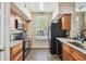 Modern kitchen with granite countertops, stainless steel appliances, and wooden cabinets at 9740 Lake Chase Island Way # 9740, Tampa, FL 33626
