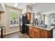 Well-lit kitchen featuring wood floors, granite counters, and a modern black refrigerator at 9740 Lake Chase Island Way # 9740, Tampa, FL 33626