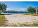 Lakeside sand volleyball court offering a fun recreational amenity with picturesque waterfront views at 9740 Lake Chase Island Way # 9740, Tampa, FL 33626