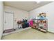 Spacious garage with ample storage shelving, a convenient workspace, and easy access to the home at 10442 Villa View Cir, Tampa, FL 33647