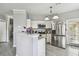 Bright, stylish kitchen featuring stainless steel appliances, granite countertops, and white cabinets at 10442 Villa View Cir, Tampa, FL 33647