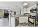 Open kitchen with stainless steel appliances and granite countertops, seamlessly flowing into the living area at 10442 Villa View Cir, Tampa, FL 33647