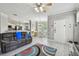 Open-concept living room features gray walls, modern ceiling fan, gray sofa with open access to dining and kitchen at 10442 Villa View Cir, Tampa, FL 33647