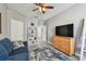 Inviting living room featuring a large flat-screen TV, comfortable seating, and a decorative area rug at 10442 Villa View Cir, Tampa, FL 33647
