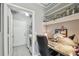 Functional office space includes built-in shelving, a desk, and a view into a laundry room for added convenience at 10442 Villa View Cir, Tampa, FL 33647