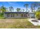 Home's backyard features a patio area, fire pit, and sunroom at 116 Solana St, North Port, FL 34287