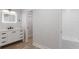 Updated bathroom showcasing modern vanity with LED mirror, light counters and view of the shower at 116 Solana St, North Port, FL 34287