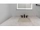 Bathroom vanity featuring marble countertops, black fixtures, and an LED mirror at 116 Solana St, North Port, FL 34287
