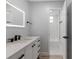 Bathroom featuring vanity with a marble top, LED mirror, and shower/tub combo at 116 Solana St, North Port, FL 34287