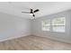 Bright bedroom featuring wood floors, neutral paint, ceiling fan and large windows at 116 Solana St, North Port, FL 34287