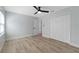 Bright bedroom featuring wood floors, ceiling fan, and double door closet at 116 Solana St, North Port, FL 34287