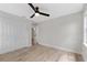Neutral bedroom with a ceiling fan, double door closet, and modern, wood-look flooring at 116 Solana St, North Port, FL 34287