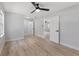 Spacious bedroom with wood-look flooring, a ceiling fan and access to other rooms at 116 Solana St, North Port, FL 34287