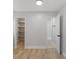 Bright bedroom with wood-look flooring, a walk-in closet and bathroom access at 116 Solana St, North Port, FL 34287