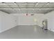 Large garage with white walls and gray flooring, offering a clean and functional space at 116 Solana St, North Port, FL 34287
