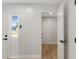 Hallway featuring white doors and trim, light wood floors, and neutral walls at 116 Solana St, North Port, FL 34287