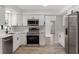 Modern kitchen with stainless steel appliances, white cabinets, and sleek countertops, blending style and function at 116 Solana St, North Port, FL 34287