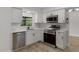 Bright kitchen with stainless steel appliances, white cabinetry, and modern finishes, offering style at 116 Solana St, North Port, FL 34287