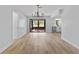 Open-concept living area with hardwood floors, natural light, and a view of the kitchen at 116 Solana St, North Port, FL 34287