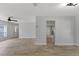 Open-concept living space featuring hardwood flooring, ceiling fan, and abundant natural light at 116 Solana St, North Port, FL 34287