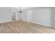 Expansive living area with modern chandelier, wood-look flooring, and neutral color palette at 116 Solana St, North Port, FL 34287