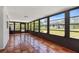 Sunroom with tiled floor, large windows and backyard views at 116 Solana St, North Port, FL 34287