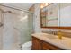 Modern bathroom with glass shower doors, updated vanity, and ample lighting at 117 Fernwood Cir # 117, Seminole, FL 33777