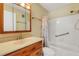 Bathroom featuring a single sink vanity with wood drawers and a shower-tub combo at 117 Fernwood Cir # 117, Seminole, FL 33777