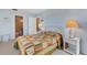 Cozy bedroom with a quilted bedspread, complemented by wicker furniture and soft lighting at 117 Fernwood Cir # 117, Seminole, FL 33777