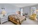 Bright bedroom featuring a quilted bedspread, wicker furniture, and plenty of natural light at 117 Fernwood Cir # 117, Seminole, FL 33777
