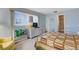 Comfortable bedroom featuring a quilted bedspread, a window with blinds, and ensuite bathroom access at 117 Fernwood Cir # 117, Seminole, FL 33777