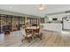 Spacious common area boasts wood-look flooring, a ceiling fan, and access to the outdoor pool area at 117 Fernwood Cir # 117, Seminole, FL 33777