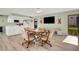 Cozy common area equipped with a dining area, kitchenette, and a large TV for entertainment at 117 Fernwood Cir # 117, Seminole, FL 33777