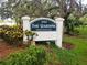 Charming community entrance sign with lush landscaping adds a touch of welcome and exclusivity at 117 Fernwood Cir # 117, Seminole, FL 33777