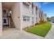 Well-maintained condo exterior with lush lawn, colorful flowerbeds, and convenient stair access at 117 Fernwood Cir # 117, Seminole, FL 33777