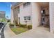 Inviting condo exterior with landscaped walkway and stairs to the second level entrance at 117 Fernwood Cir # 117, Seminole, FL 33777
