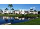 Scenic view of condo buildings reflecting in the tranquil waters with lush landscaping at 117 Fernwood Cir # 117, Seminole, FL 33777