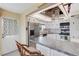 Well-lit kitchen with stainless steel appliances, bar seating, and a convenient door to the outside at 117 Fernwood Cir # 117, Seminole, FL 33777