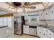 Updated kitchen includes stainless steel refrigerator, dishwasher, and ample cabinet space at 117 Fernwood Cir # 117, Seminole, FL 33777