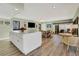 Open concept living area with island, dining space, wood flooring and comfortable seating at 117 Fernwood Cir # 117, Seminole, FL 33777