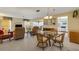 Comfortable living room with a dining area and a glimpse into the white kitchen at 117 Fernwood Cir # 117, Seminole, FL 33777