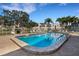 Inviting outdoor pool surrounded by lounge chairs and lush landscaping, perfect for relaxation and enjoyment at 117 Fernwood Cir # 117, Seminole, FL 33777