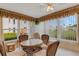 Bright sunroom with a glass table, wicker chairs, and views of the outdoors at 117 Fernwood Cir # 117, Seminole, FL 33777