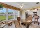 Inviting sunroom featuring a glass table, wicker chairs, and a view to the kitchen at 117 Fernwood Cir # 117, Seminole, FL 33777