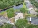 Aerial view of a house with a screened pool and a pond at 12304 Freesia Ct, Riverview, FL 33569